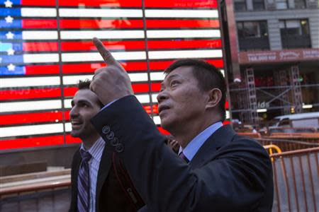 Weibo Corporation Chairman Charles Chao (R) walks through Times Square following a visit to the NASDAQ MarketSite in Times Square in celebration of Weibo's initial public offering (IPO) on The NASDAQ Stock Market in New York April 17, 2014. REUTERS/Andrew Kelly