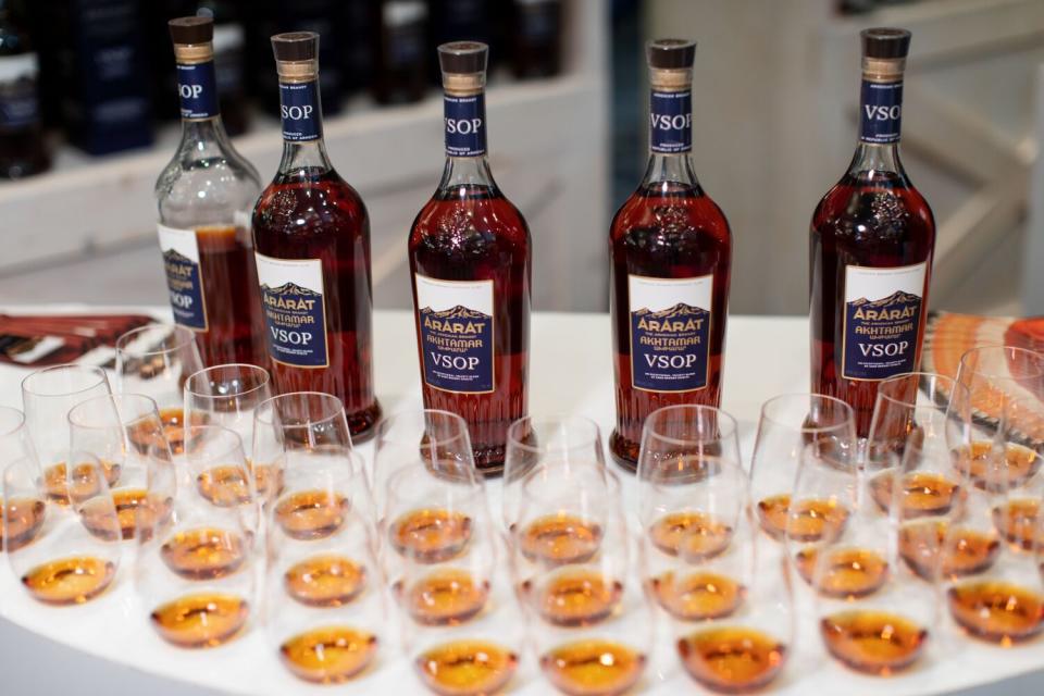 Bottles of Armenian brandy on a table with glasses containing samples