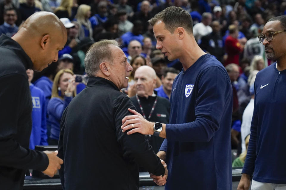 Duke head coach Jon Scheyer, right, shakes hands with Michigan State head coach Tom Izzo after an NCAA college basketball game, Tuesday, Nov. 14, 2023, in Chicago. (AP Photo Erin Hooley)