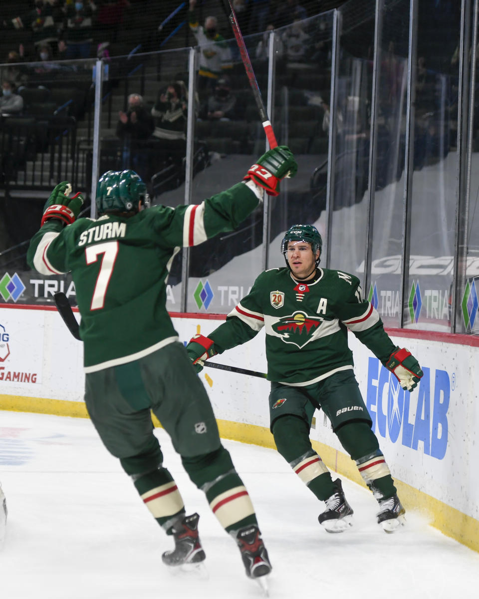 Minnesota Wild left wing Zach Parise, right, and center Nico Sturm celebrate after Parise scored a goal against the San Jose Sharks during the first period of an NHL hockey game Saturday, April 17, 2021, in St. Paul, Minn. (AP Photo/Craig Lassig)