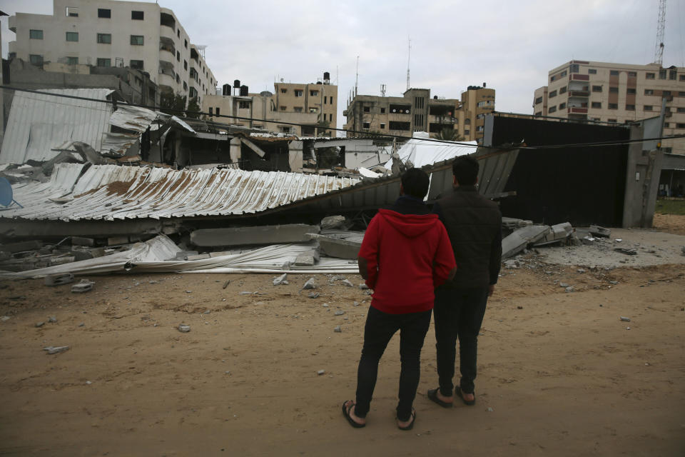 Palestinians check the damage of destroyed building belongs to Hamas ministry of prisoners hit by Israeli airstrikes in Gaza City, early Friday, Friday, March 15, 2019. Israeli warplanes attacked militant targets in the southern Gaza Strip early Friday in response to a rare rocket attack on the Israeli city of Tel Aviv, as the sides appeared to be hurtling toward a new round of violence. (AP Photo/Adel Hana)