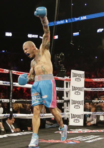 Miguel Cotto, of Puerto Rico, celebrates after beating Daniel Geale, of Australia, in a boxing match Saturday, June 6, 2015, in New York. (AP Photo/Frank Franklin II)