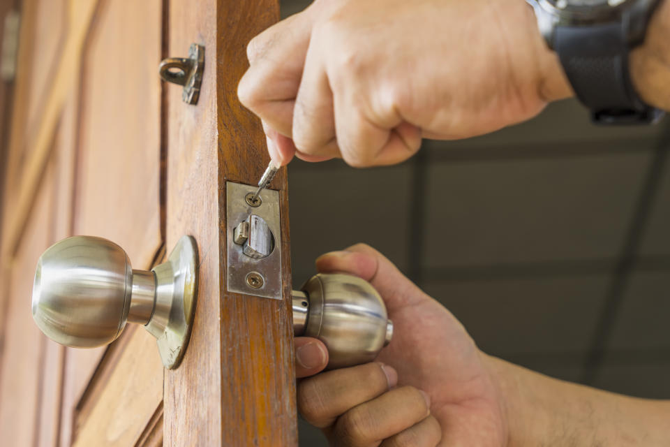 close-up locksmith repair silver lock on wood door - can use to display or montage on product