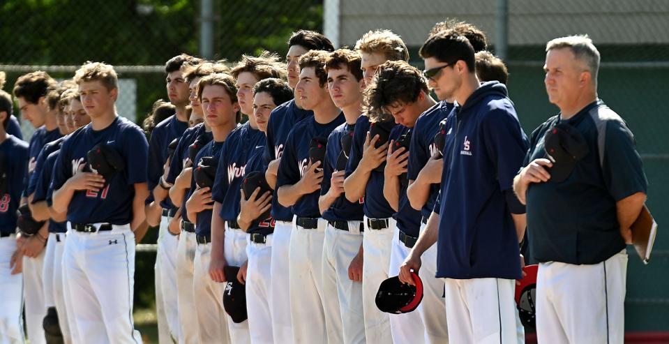 The Lincoln-Sudbury baseball team stands for the national anthem before playing Hopkinton in the opening round of the 14th annual Rich Pedroli Memorial Daily News Classic, at Mahan Field in Natick, May 26, 2022.  The  4-team baseball tournament is played in honor of Rich Pedroli, a former Daily News editor who died in 2006.