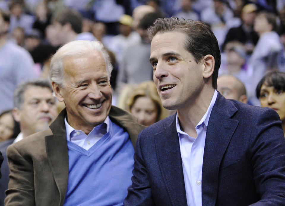 FILE - Then Vice President Joe Biden, left, and his son Hunter Biden appear at the Duke Georgetown NCAA college basketball game in Washington on Jan. 30, 2010. Hunter Biden, an ongoing target for conservatives, has a memoir coming out April 6. The book is called “Beautiful Things” and will center on the younger Biden's well publicized struggles with substance abuse, according to his publisher. (AP Photo/Nick Wass, File)