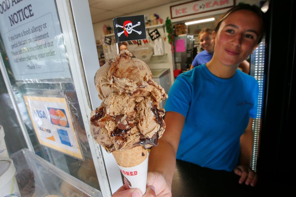 Lauryn Costa, manager, offers an espresso chocolate chip sugar cone ice cream at the Captain Bonney's Creamery on New Bedford Road in Rochester.