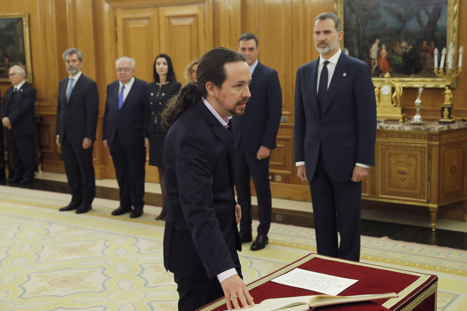 Podemos (United We Can) leader Pablo Iglesias takes his oath of office during the swearing in ceremony at the Zarzuela Palace just outside of Madrid, Spain, Monday Jan. 13, 2020. Iglesias will be the deputy prime minister in charge of social rights and sustainable development in. in Spain's center to far left-wing coalition administration. (Chema Moya/ Pool Photo via AP)