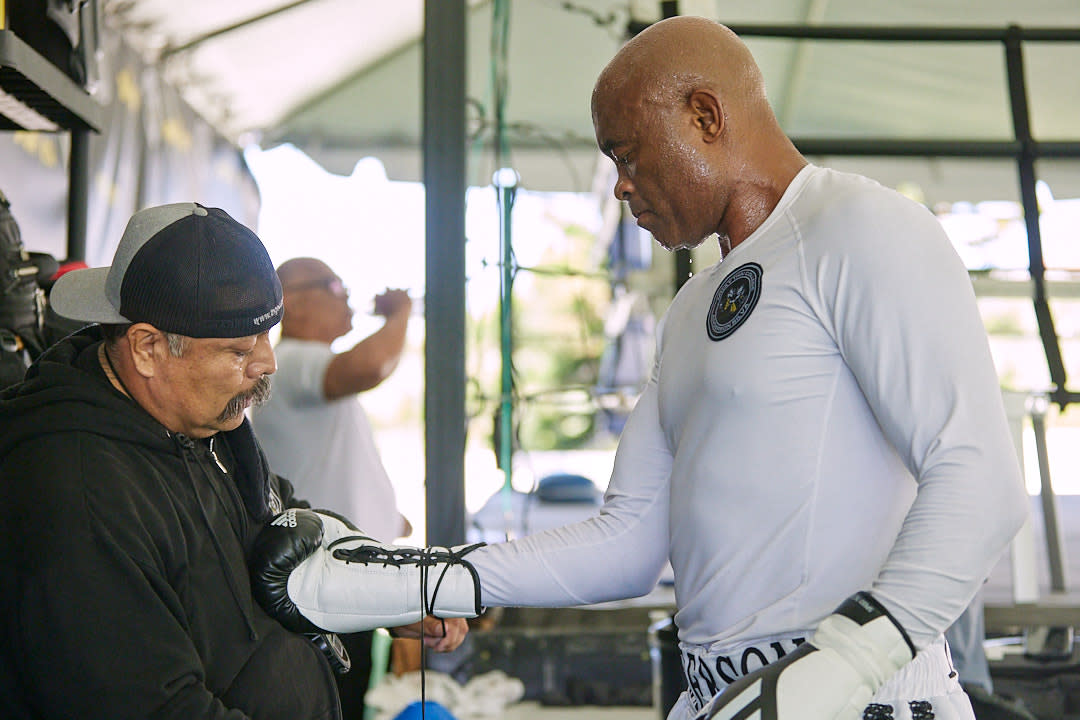 Nico Robledo Jr. ties the gloves for Anderson Silva during training ahead of the ex-UFC champi's boxing match versus Jake Paul. (Photo credit: Esther Lin/SHOWTIME)