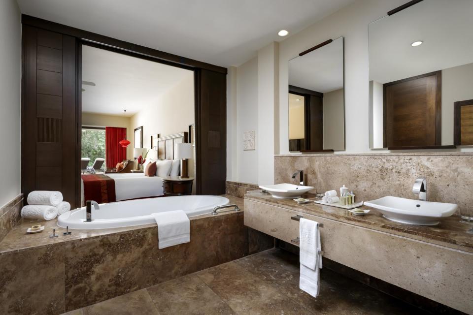 Bathrooms feature deep jacuzzi tubs at Grand Velas Riviera Maya