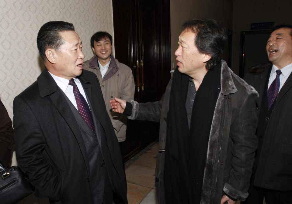 South Korean conductor Chung Myung-whun, second from right, is greeted by an official from the Society for the Study of Korean National Music, at Pyongyang airport, in North Korea Tuesday Feb. 28, 2012. Chung, of the Seoul Philharmonic Orchestra, is to rehearse with North Korea's Unhasu Orchestra before the musicians make a trip to Paris for a rare joint performance with the Radio France Philharmonic Orchestra next month. (AP Photo/Kim Kwang Hyon)