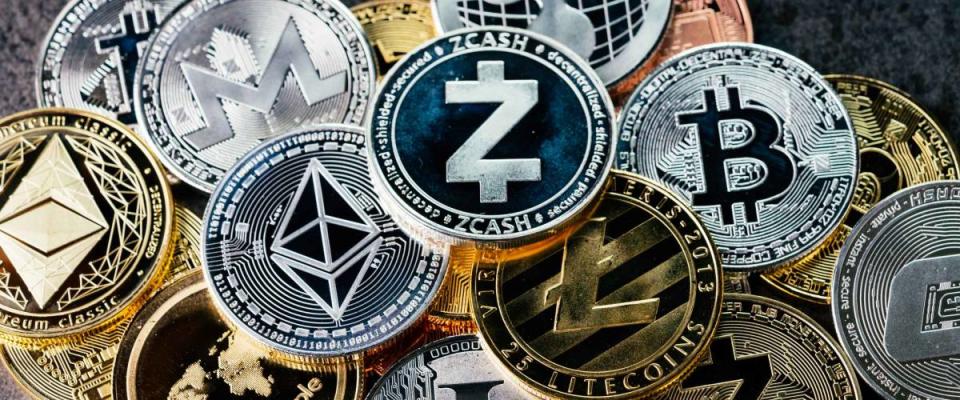 Crypto currency background with various of shiny silver and golden physical cryptocurrencies symbol coins, Bitcoin, Ethereum, Litecoin, zcash, ripple.