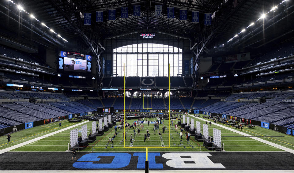 NCAA college football players and coaches take turns at a podiums to respond to reporter's questions at the Big Ten Conference media days, Thursday, July 22, 2021, at Lucas Oil Stadium in Indianapolis. (AP Photo/Doug McSchooler)