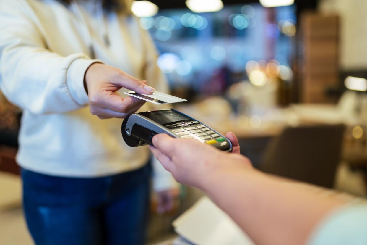 Furniture store owner receives contactless payment due to social distancing