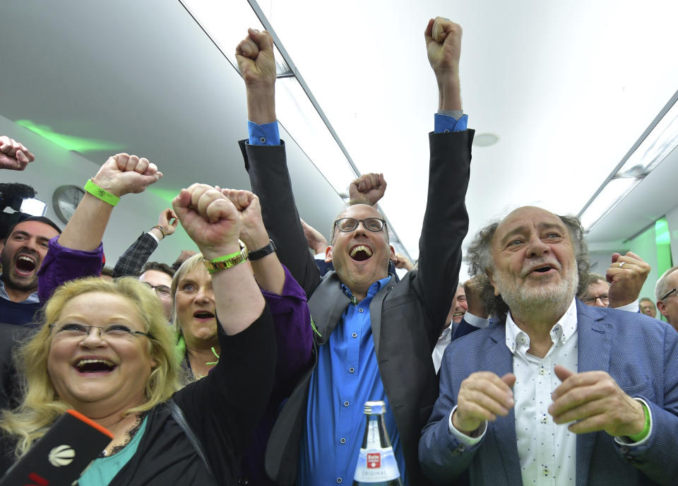 Supporters of the Green party celebrate after the state election in the German state of Hesse in Wiesbaden, western Germany, Sunday, Oct. 28, 2018. Exit polls show Chancellor Angela Merkel’s party leading with a significant drop in support for both her conservatives and their center-left partners in the national government. (Uwe Anspach/dpa via AP)