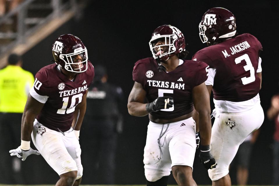 Sep 2, 2023; College Station, Texas; Texas A&M Aggies defensive back Jacoby Mathews (2), defensive lineman Fadil Diggs (10) and defensive lineman Shemar Turner (5) react to a tackle for a loss during the fourth quarter against the New Mexico Lobos at Kyle Field. Maria Lysaker-USA TODAY Sports