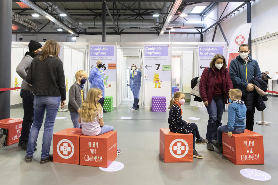 Children wait with their parents to receive the Pfizer vaccine against the COVID-19 disease. The official vaccination for children between the age of 5 and 12 years start today in Vienna, Austria, Monday, Nov. 15, 2021. (AP Photo/Lisa Leutner)