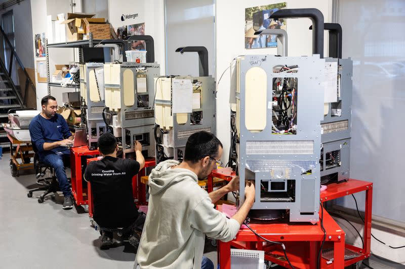 People work in the research and development centre of Watergen, a company that extracts drinking water from the air, in Petah Tikva