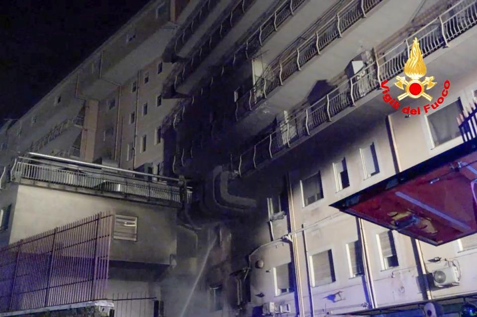 Firefighters spray water at the Italian hospital after a fire broke out (Italian Firefighters Via AP)