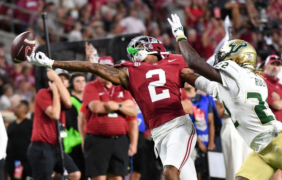 Sep 7, 2024; Tuscaloosa, Alabama, USA; A pass from Alabama Crimson Tide quarterback Jalen Milroe (4) is just off the fingertips of Alabama Crimson Tide wide receiver Ryan Williams (2) as he is closely defended by South Florida Bulls cornerback De'Shawn Rucker (22) at Bryant-Denny Stadium. Alabama defeated South Florida 42-16. Mandatory Credit: Gary Cosby Jr.-Imagn Images