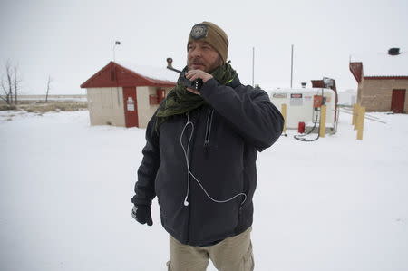 An occupier uses a radio near a gas storage facility at the Malheur National Wildlife Refuge near Burns, Oregon, January 5, 2016. REUTERS/Jim Urquhart