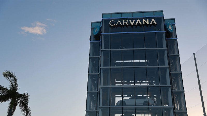 A photo of a tower of cars with the Carvana logo on top. 