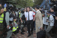 In this Monday, Nov. 25, 2019, photo, lawyer Daniel Wong Kwok-tung, center, arrives at the Polytechnic University to meet the protesters in Hong Kong. Hong Kong national security police on Thursday, Jan. 14, 2021, arrested a lawyer and 10 others on suspicion of helping 12 Hong Kongers try to flee the city, local media reported in the latest arrests in an ongoing crackdown on dissent. Wong, a member of the city's Democratic Party, is known for providing legal assistance to hundreds of protesters arrested during the anti-government protests in Hong Kong in 2019. (AP Photo/Kin Cheung)