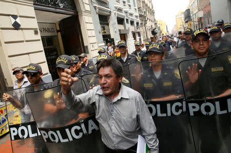 People protest against Peru's President Pedro Pablo Kuczynski's government near the Government Palace in Lima, Peru March 21, 2018. REUTERS/Guadalupe Pardo