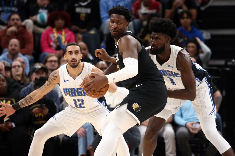 Jan 26, 2024; Memphis, Tennessee, USA; Memphis Grizzlies forward-center Jaren Jackson Jr. (13) spins toward the basket as Orlando Magic forward Jonathan Isaac (1) defends during the first half at FedExForum. Mandatory Credit: Petre Thomas-USA TODAY Sports