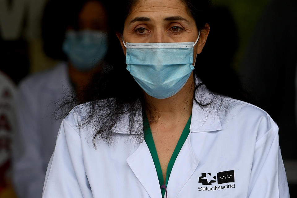 Healthcare workers observe a minute of silence to pay tribute to their fallen colleagues outside the Gregorio Maranon Hospital in Madrid on May 14, 2020, during the national lockdown to prevent the spread of the COVID-19 disease. (Photo by Gabriel BOUYS / AFP) (Photo by GABRIEL BOUYS/AFP via Getty Images)