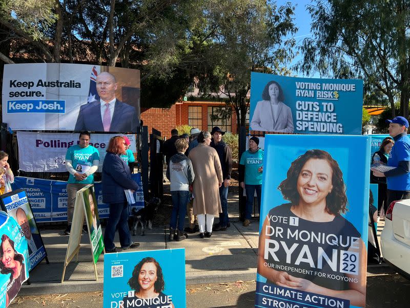 FILE PHOTO: Voters line up outside a polling station for the electorate of Kooyong during the national election, in Surrey Hills