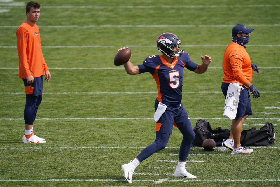 Denver Broncos quarterback Blake Bortles, front, takes part in drills as injured quarterback Drew Lock looks on during an NFL football practice Thursday, Sept. 24, 2020, in Englewood, Colo. (AP Photo/David Zalubowski)   