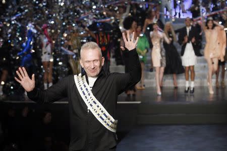 French designer Jean Paul Gaultier reacts as he appears at the end of his Spring/Summer 2015 women's ready-to-wear collection during Paris Fashion Week September 27, 2014. REUTERS/Gonzalo Fuentes