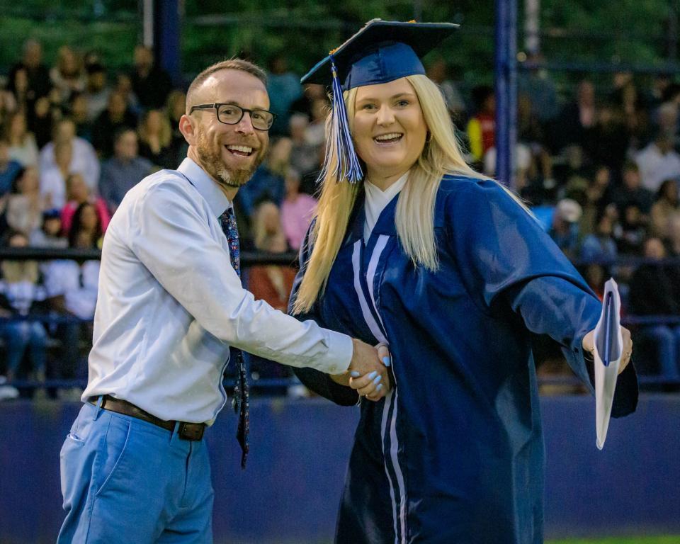 Molly Callahan is congratulated by Rockland High teacher Chad Bigsby after receiving her diploma Friday, June 3, 2022.