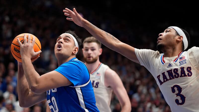 BYU center Aly Khalifa looks to shoot under pressure from Kansas guard Dajuan Harris Jr. (3) during game Tuesday, Feb. 27, 2024, in Lawrence, Kan. BYU won 76-68.