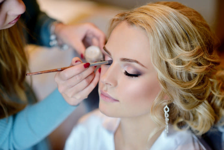 A bride getting her makeup done.