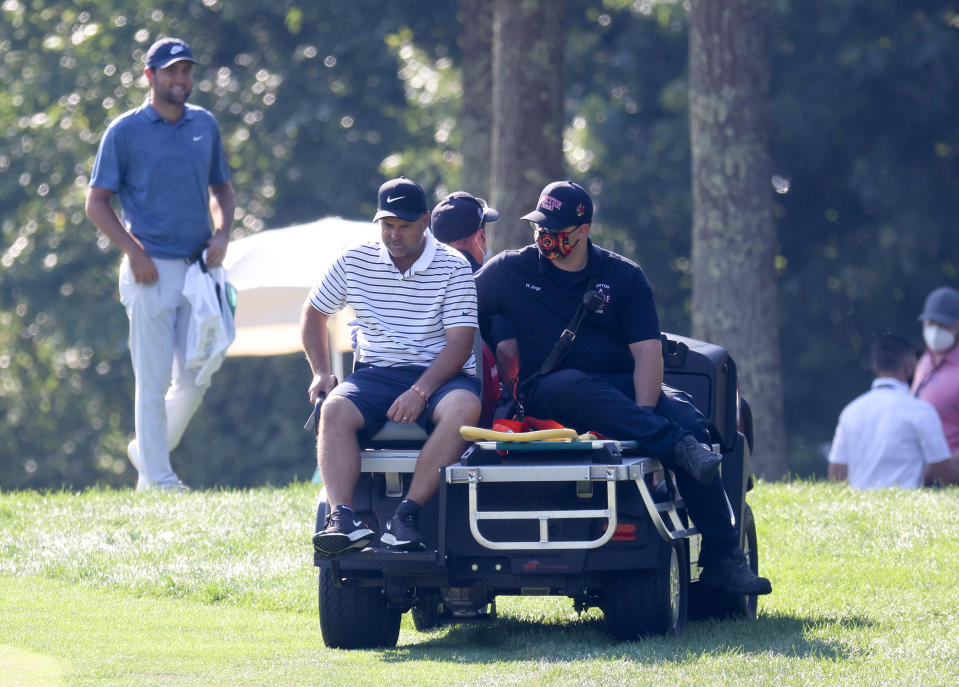 Scott McGuinness rides on a cart.