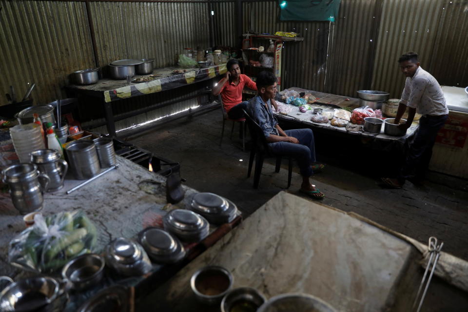 Workers are seen inside the kitchen of a dhaba, a small restaurant along a national highway in Gharaunda