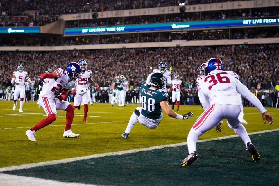 Philadelphia Eagles tight end Dallas Goedert (88) scores a touchdown on a pass from quarterback Jalen Hurts, not visible, as New York Giants players surround him during the first half of an NFL divisional round playoff football game, Saturday, Jan. 21, 2023, in Philadelphia.