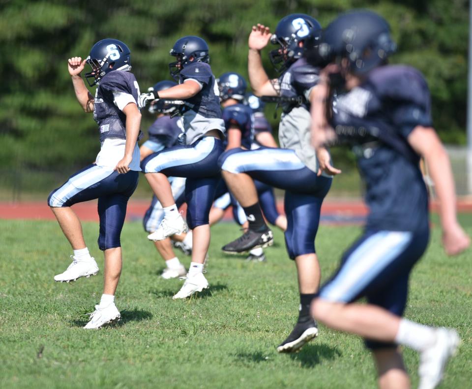 Morning stretches to start a practice for the Sandwich High School football team.