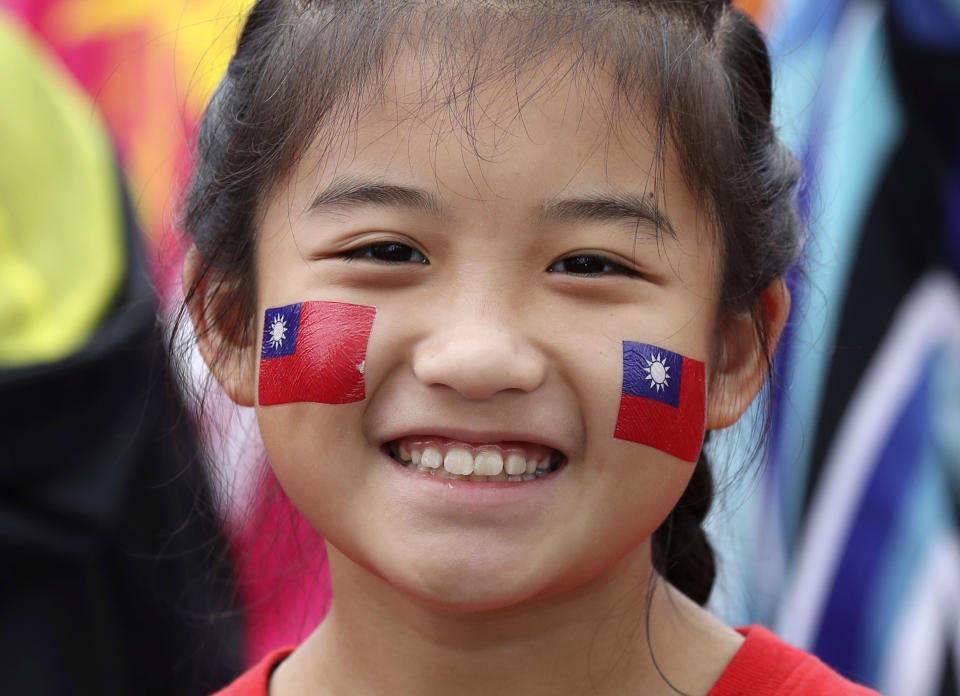 A Taiwanese girl has Taiwan national flag painted on her face during the National Day celebrations in Taipei, Taiwan, Saturday, Oct. 10, 2020. (AP Photo/Chiang Ying-ying)