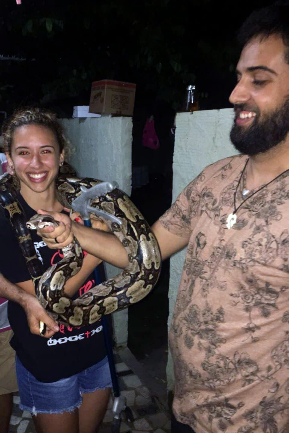 The woman's neighbour is pictured with the snake around her neck. Photo: Caters News