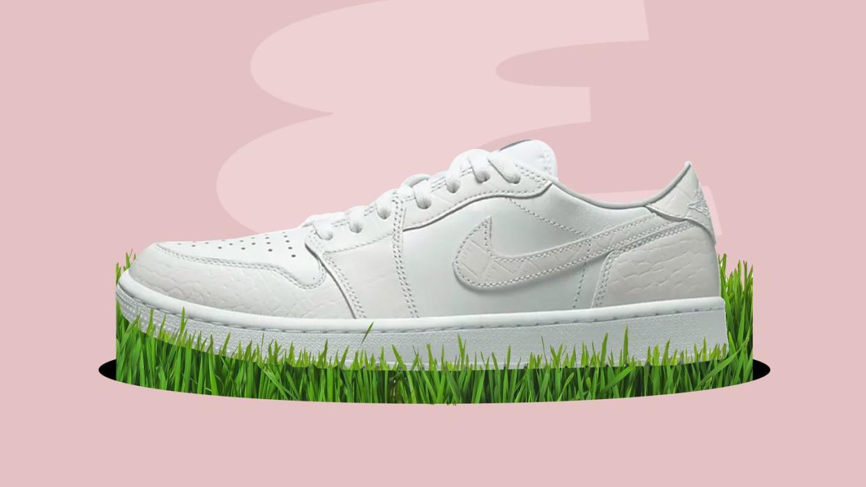 a pair of white sneakers on a green grass