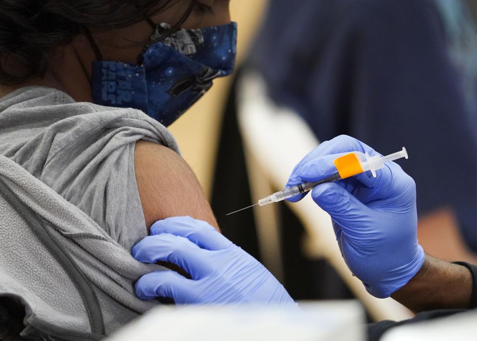 A youth receives a shot during Arizona's first COVID-19 vaccination site for underserved youths ages 12 to 15 at C.O. Greenfield Elementary School in Phoenix on May 13, 2021.