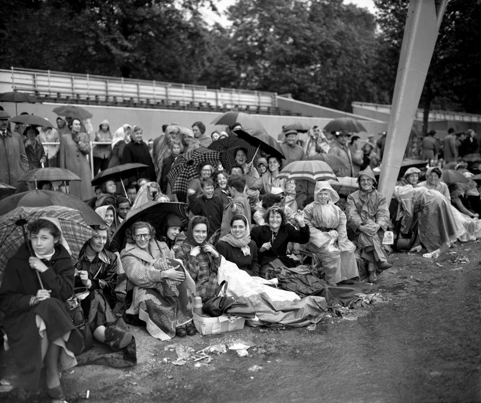 On the pavements between Buckingham Palace and Westminster, a crowd waits for the coronation procession. (Getty Images)