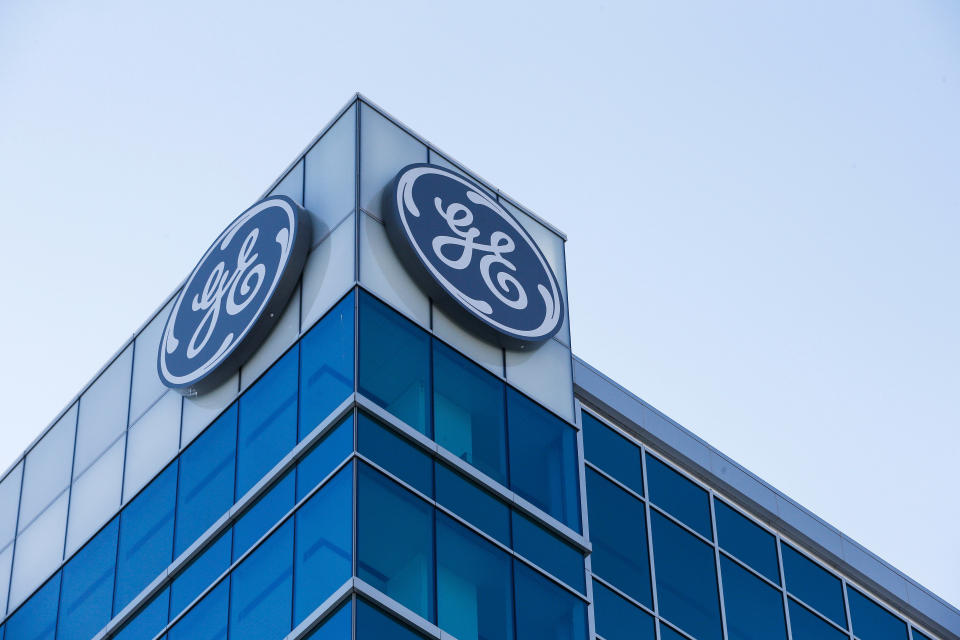 FILE- In this Jan. 16, 2018, file photo, the General Electric logo is displayed at the top of their Global Operations Center in the Banks development of downtown Cincinnati. Industrial giant General Electric is naming H. Lawrence Culp Jr. as its chairman and CEO. Culp, former CEO and president of Danaher Corp., succeeds John Flannery in the posts.  (AP Photo/John Minchillo, File)