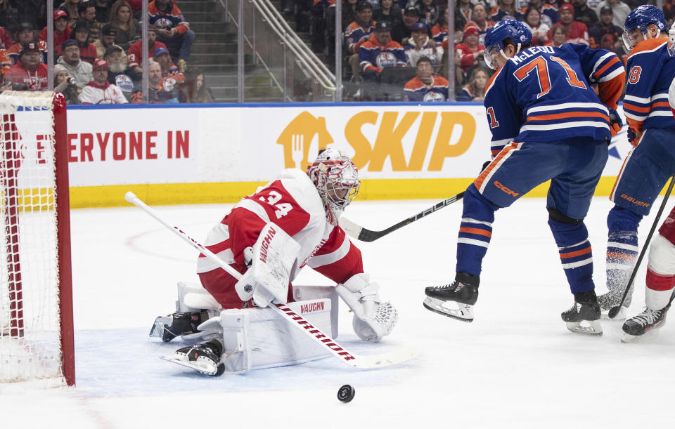 Detroit Red Wings' goalie Alex Lyon (34) makes a save on Edmonton Oilers' Ryan McLeod (71) during the second period of an NHL hockey game Tuesday, Feb. 13, 2024, in Edmonton, Alberta. (Jason Franson/The Canadian Press via AP)