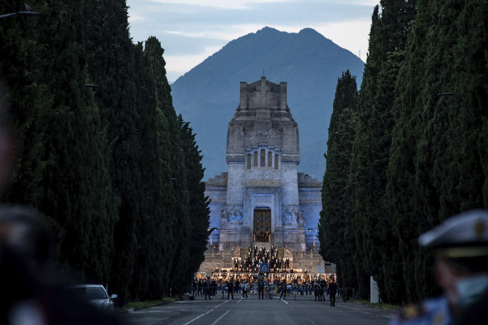 Musicians perform in front of the Bergamo cemetery, Italy, Sunday, June 28, 2020. Italy bid farewell to its coronavirus dead on Sunday with a haunting Requiem concert performed at the entrance to the cemetery of Bergamo, the hardest-hit province in the onetime epicenter of the outbreak in Europe. President Sergio Mattarella was the guest of honor, and said his presence made clear that all of Italy was bowing down to honor Bergamo’s dead, “the thousands of men and women killed by a sickness that is still greatly unknown and continues to threaten the world.” (Claudio Furlan/LaPresse via AP)