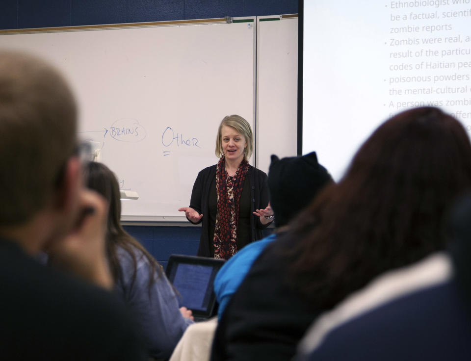 In a photo provided by Central Michigan Univserity, Kelly Murphy, a philosophy and religion faculty member at Central Michigan University, teaches a religion course titled "From Revelation to'The Walking Dead'" Thursday, Jan. 23, 2014, in Mount Pleasant, Mich. The course explores biblical texts and apocalyptic themes in media. (AP Photo/Christina Kurtz)