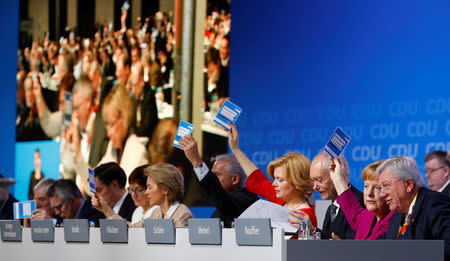 German Chancellor Angela Merkel and delegates vote during a Christian Democratic Union (CDU) party congress in Berlin, Germany, February 26, 2018. REUTERS/Fabrizio Bensch