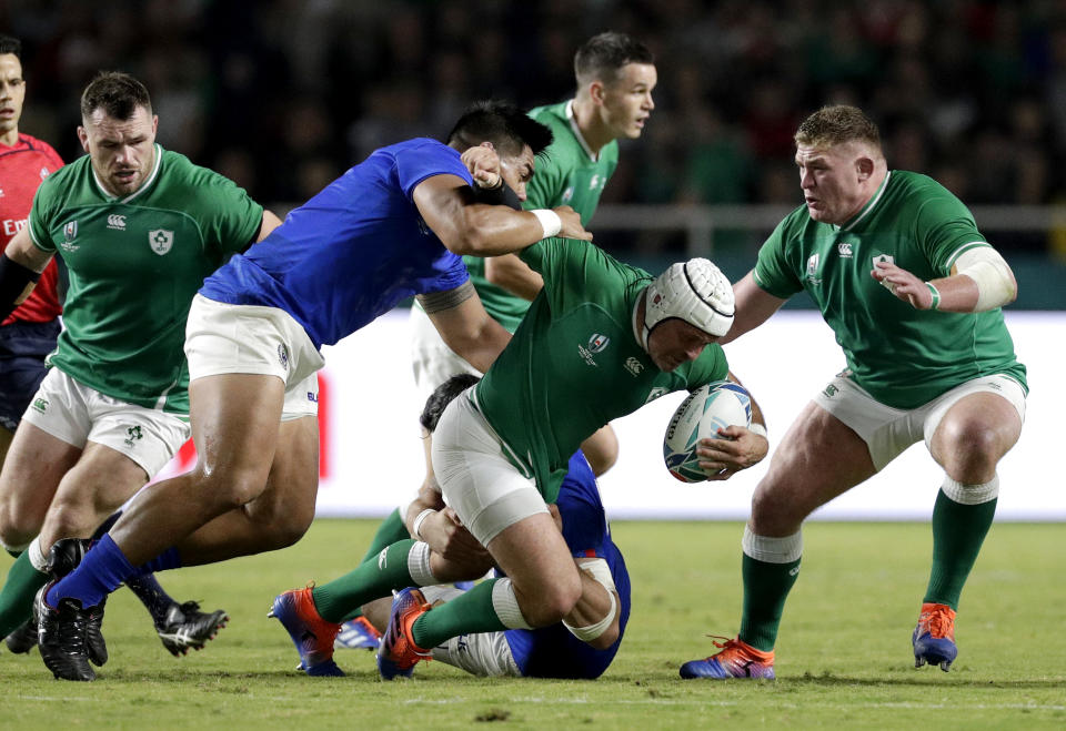 Ireland's Rory Best is tackled by the Samoan defence during the Rugby World Cup Pool A game at Fukuoka Hakatanomori Stadium between Ireland and Samoa, in Fukuoka, Japan, Saturday, Oct. 12, 2019. (AP Photo/Aaron Favila)